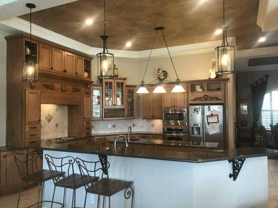 Wood cabinets, dark granite, painted ceiling accent