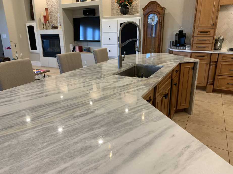 white marble counters and maple wood cabinets