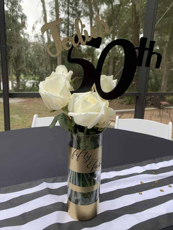 vase with white roses and 50th birthday sign
