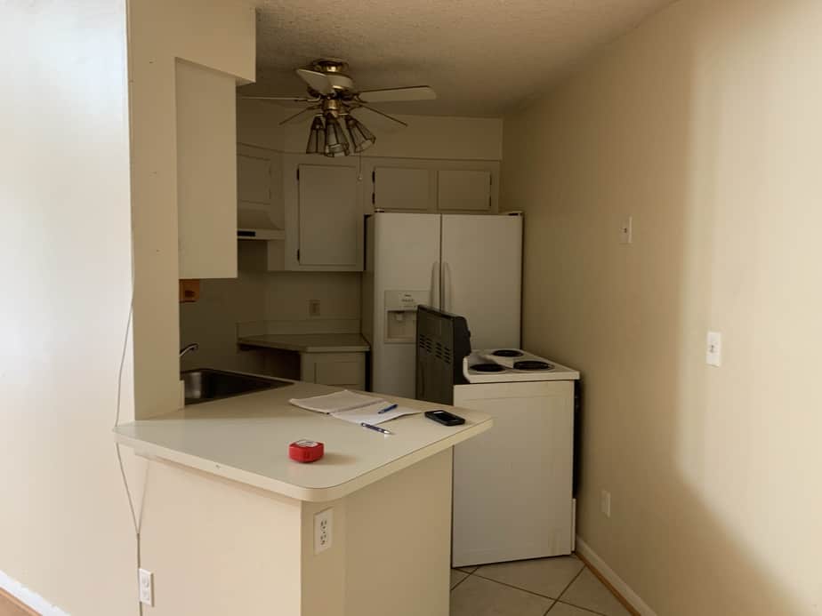 condo kitchen remodel before and after. Before photo showing dark narrow kitchen