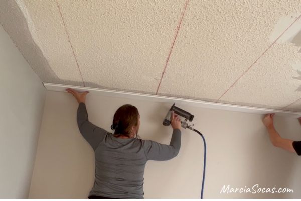 installing shiplap ceiling along the ceiling