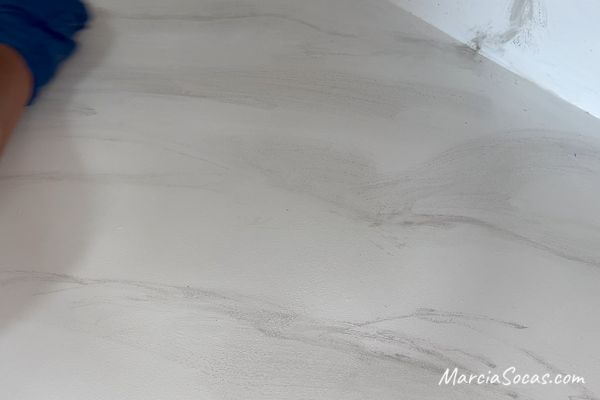 using brush and paper towel on faux marble countertop