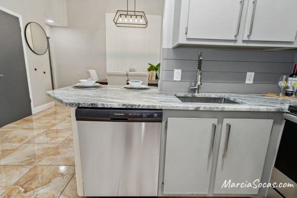 condo kitchen renovated with shiplap backsplash