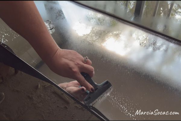 scraping off excess overspray