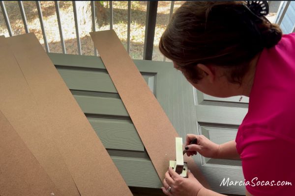 placing hardboard on door by doorknob