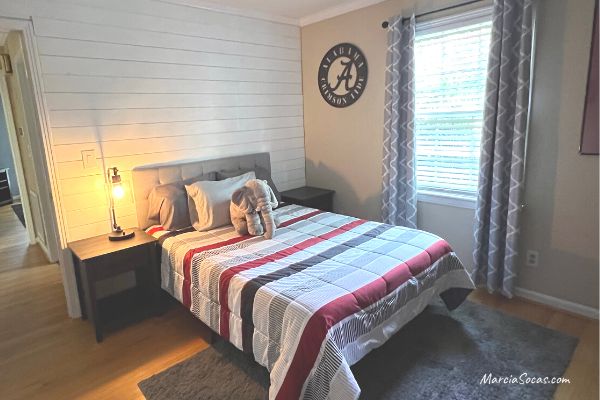 renovated bedroom at Alabama Airbnb with shiplap wall