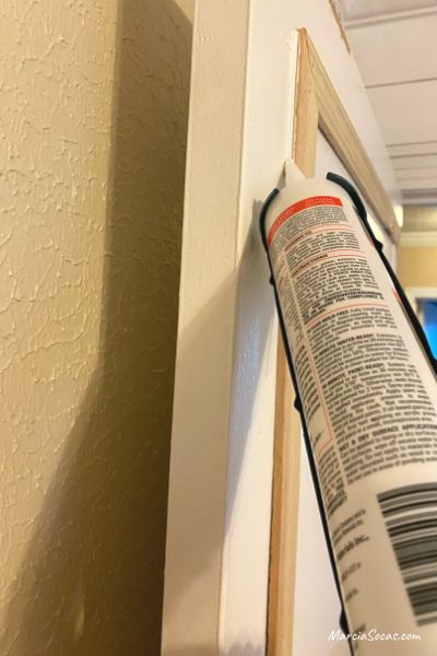 adding paintable sealant to door molding