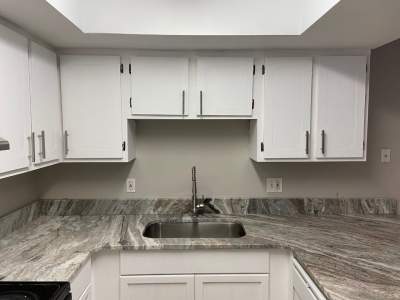 white kitchen cabinet with cabinet pulls