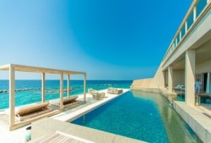 architectural photography of gray granite swimming pool and outdoor lounge at beach side