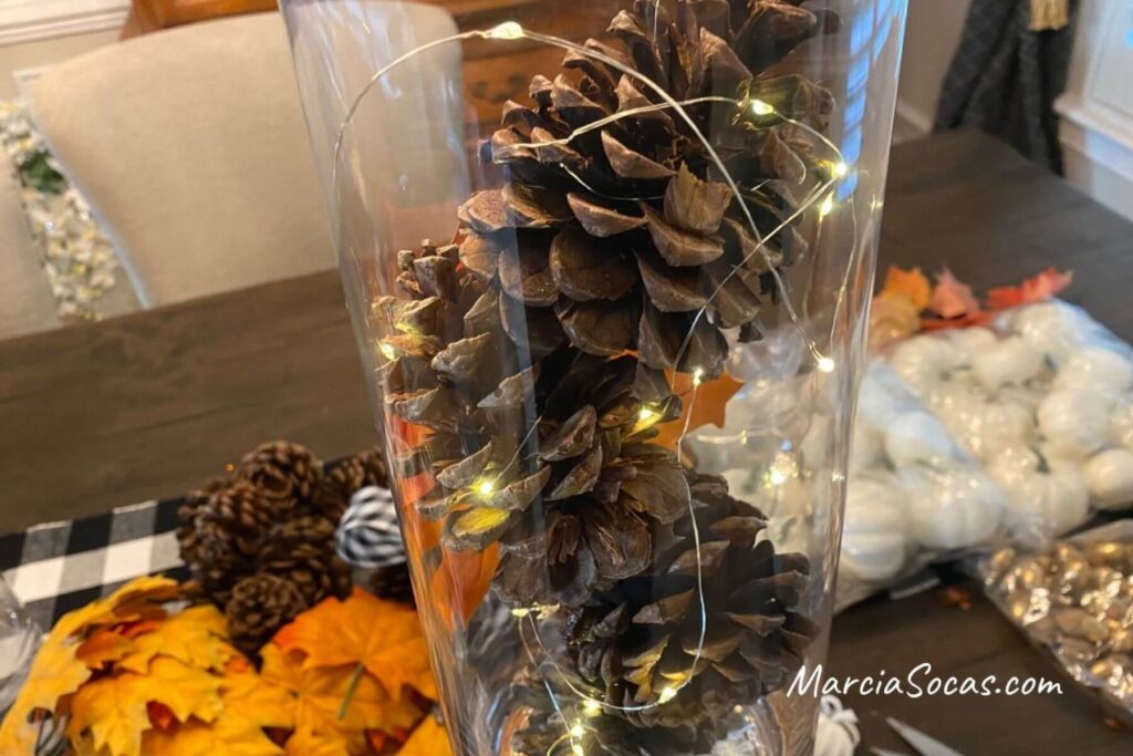 making pine cones with fairy lights vase