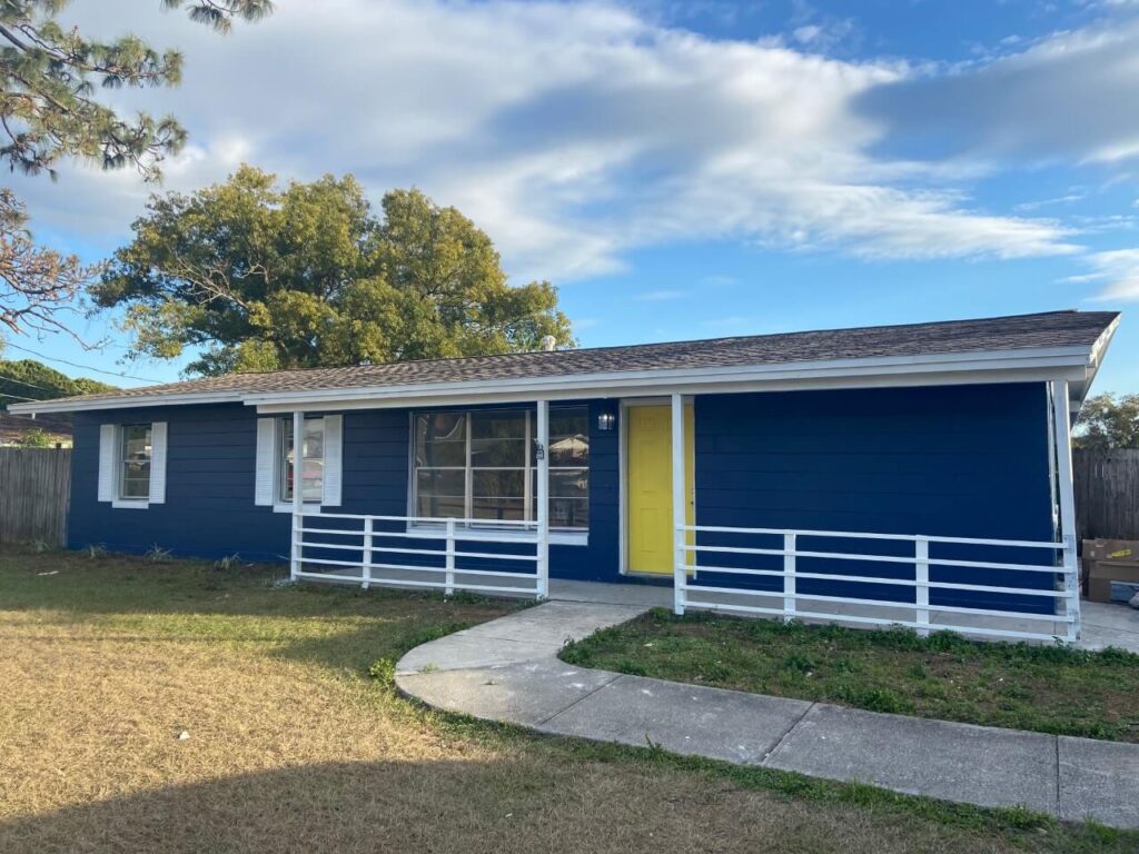 Blue home, white trim, yellow door