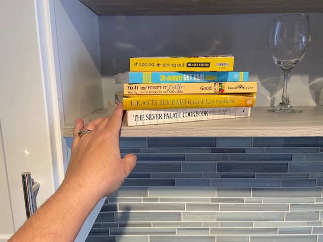 stacking books in open shelving